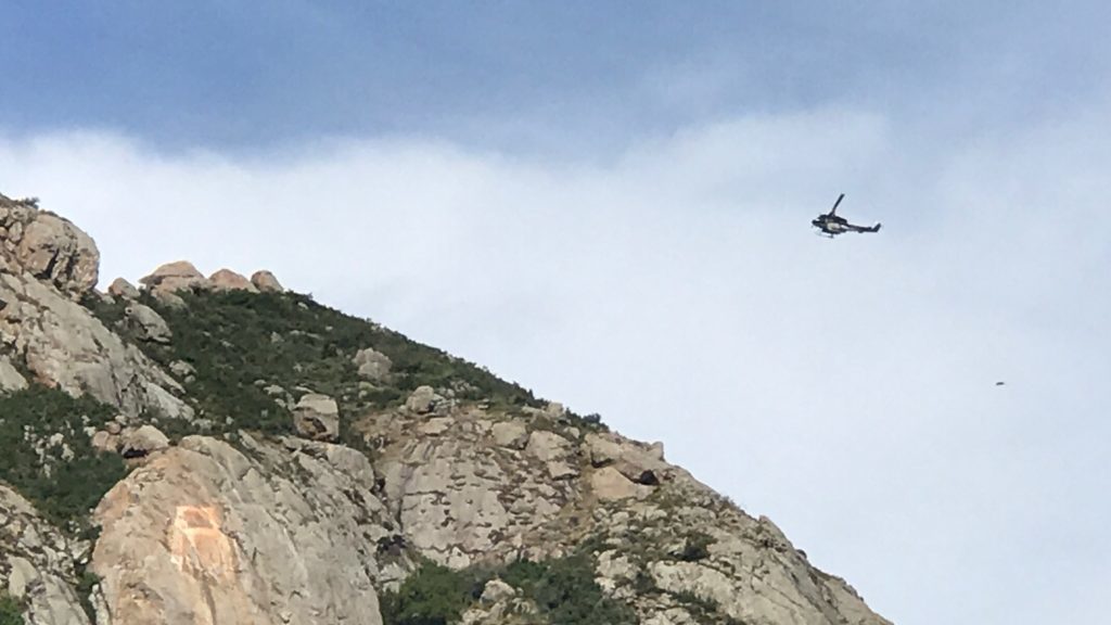 A helicopter on scene to assist with the rescue. (KSBY photo)